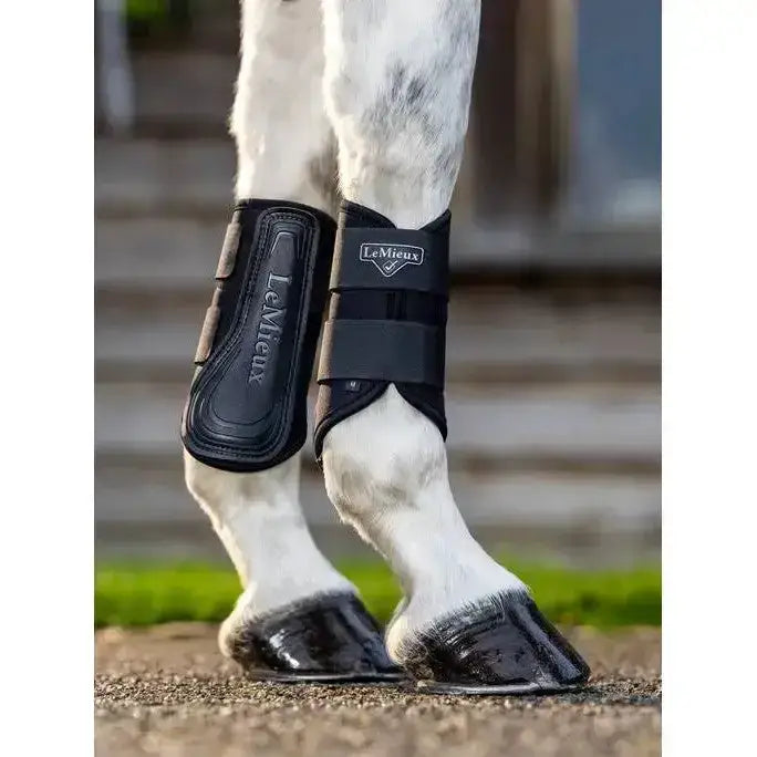 Black lemieux grafter brushing boot with padded straps and a sleek highly durable design for horse leg protection