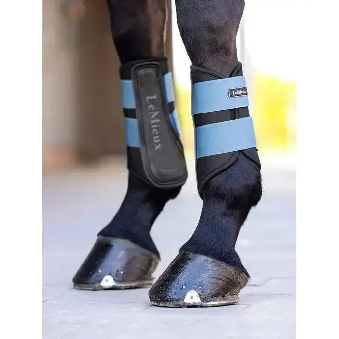 Black and light blue lemieux grafter brushing boot with adjustable straps made for durability and protection