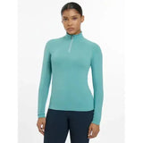 Teal long-sleeved lemieux halle lightweight base layer lagoon with quarter-zip neckline for active wear