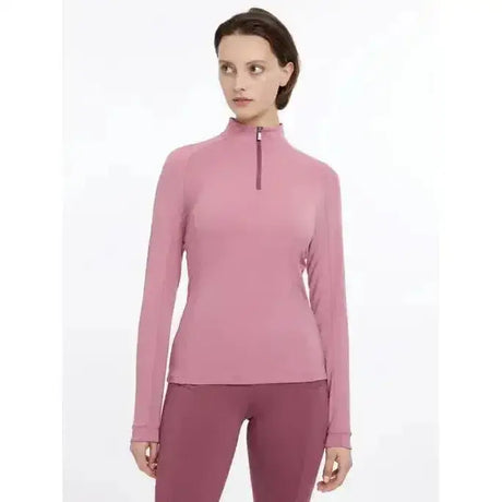A soft pink lemieux halle lightweight base layer peony with long sleeves and a snug half-zip fit
