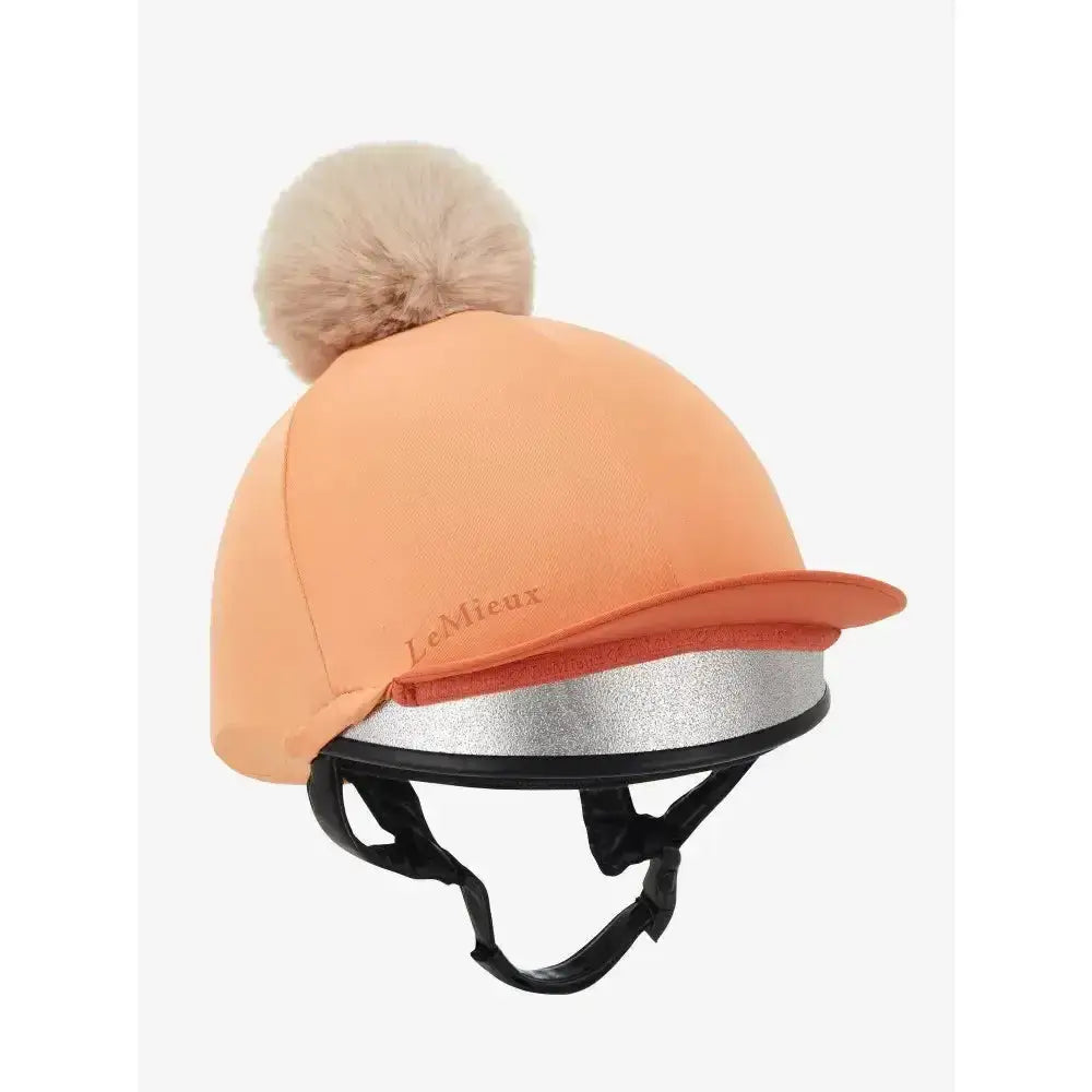 Peach-colored lemieux hat silk sherbet equestrian helmet cover with fluffy beige pom-pom and silver reflective band