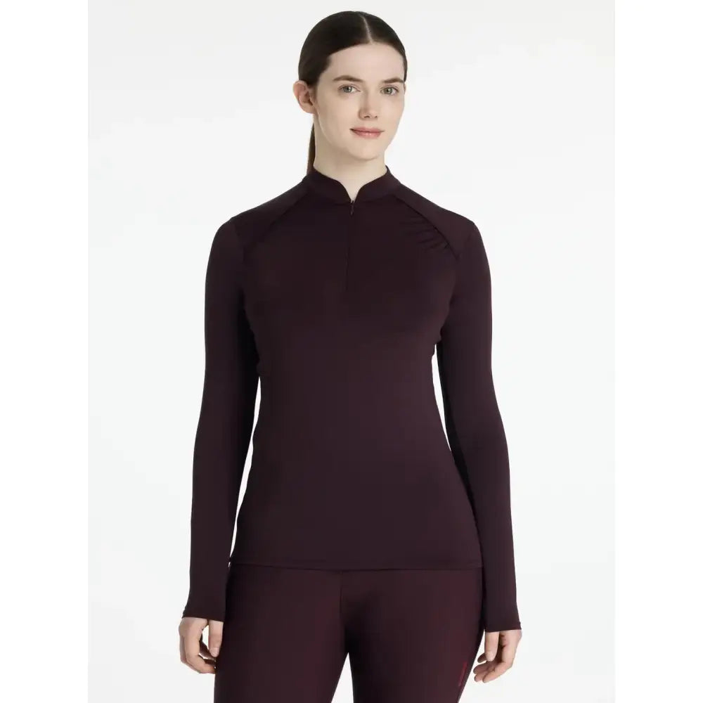 A sleek lemieux heyden lightweight base layer in damson colour with a high collar and quarter-zip closure