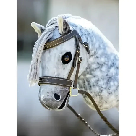 A lemieux hobby horse hunter bridle on a plush white and gray dapple horse head with brown leather straps