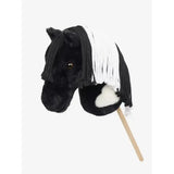 Black plush lemieux hobby horse razzle with white fringe mane and fluffy white chest patch on a wooden stick
