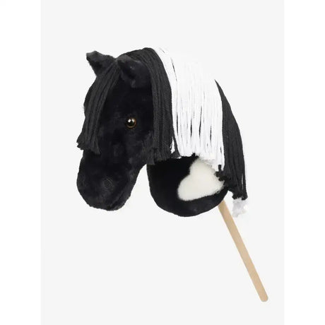Black plush lemieux hobby horse razzle with white fringe mane and fluffy white chest patch on a wooden stick