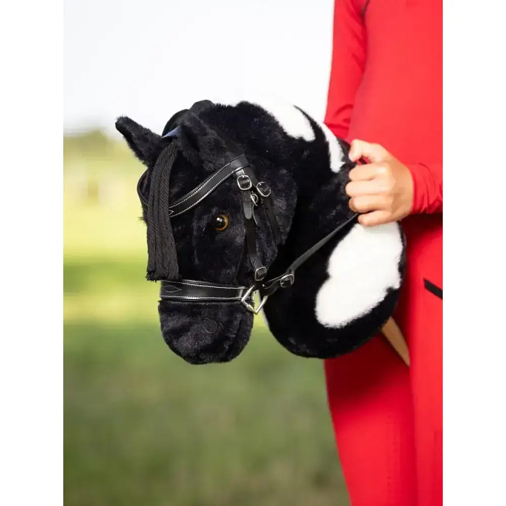 Black and white plush lemieux hobby horse backpack with faux leather bridle details hobby horse razzle design