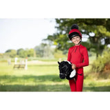 Red lemieux hobby horse razzle equestrian helmet with black visor and pom pom for safe riding sessions