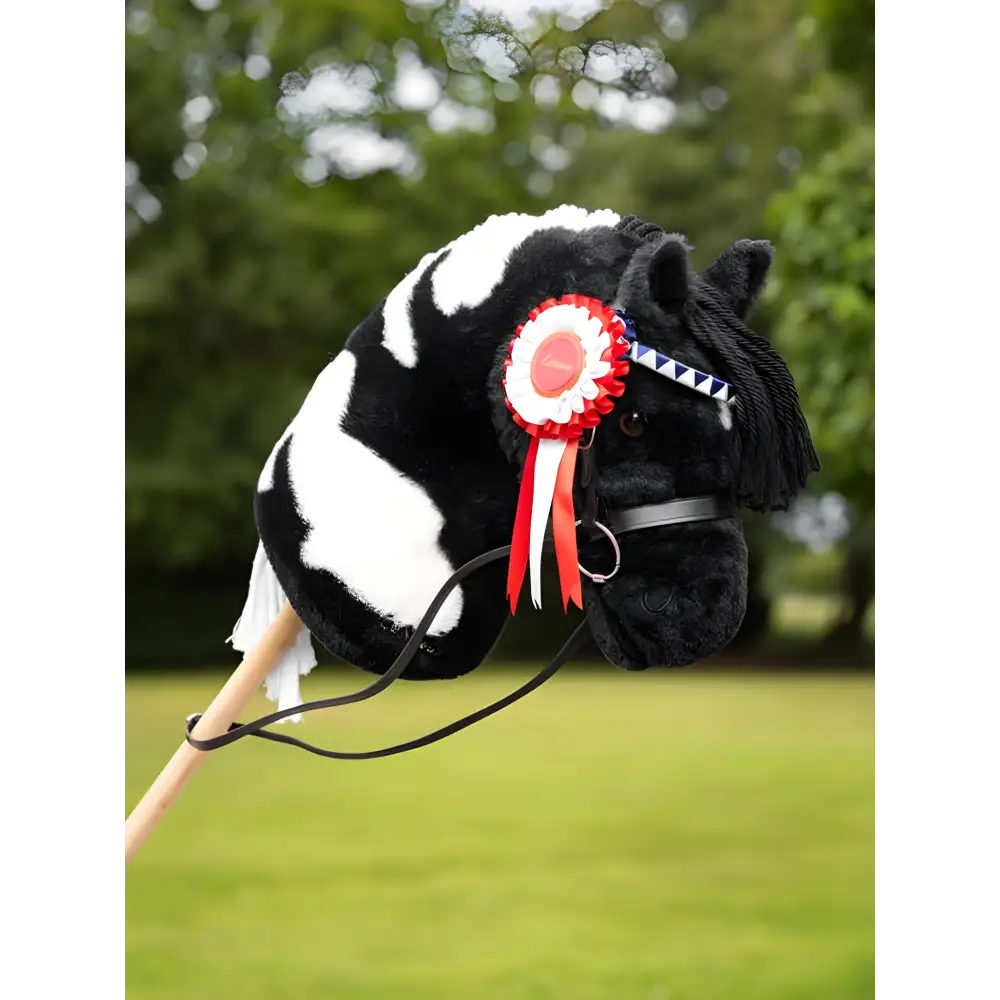 Hobby horse with black and white coloring featuring a red rosette from Lemieux Hobby Horse