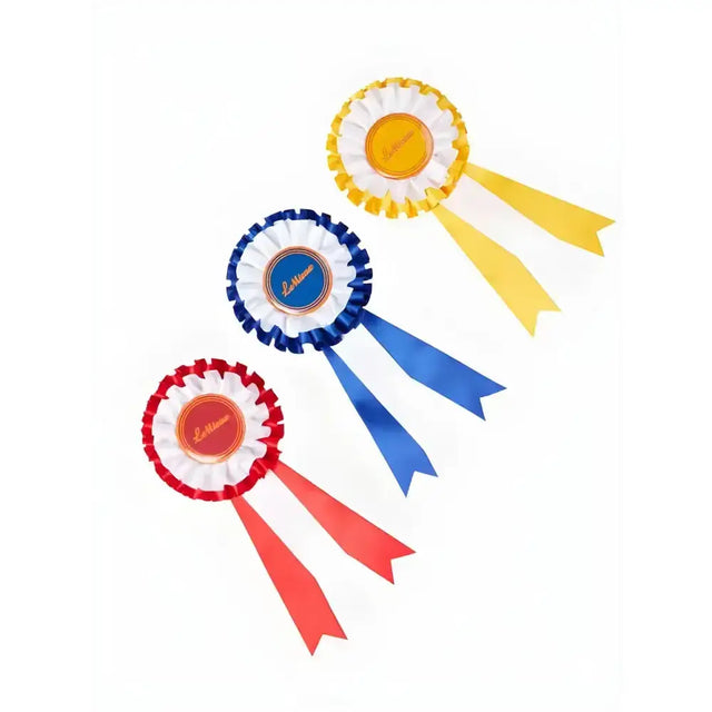Three colorful lemieux hobby horse rosettes in red white blue white and yellow white with ladies winner’s rosettes