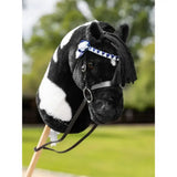 Black and white lemieux hobby horse head with blue triangular showing bridle and black leather straps with bow