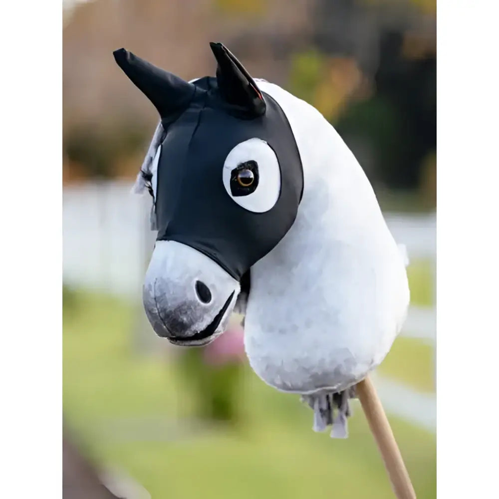 Black and white lemieux hobby horse stay calm mask with cartoonish eye design mounted on a wooden stick