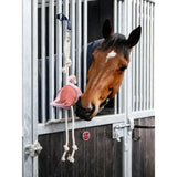 Pink lemieux horse toy flamingo with rope handles and blue strap hanging from stable bars for horse play