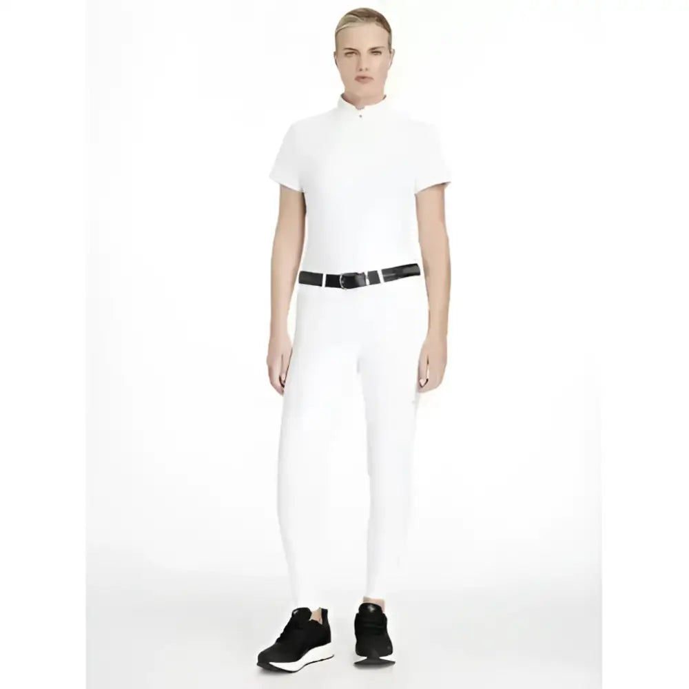 White lemieux imogen knee grip breeches paired with a white equestrian-style polo shirt with short sleeves and high collar