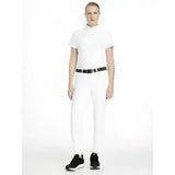 White lemieux imogen knee grip breeches paired with a white equestrian-style polo shirt with short sleeves and high collar