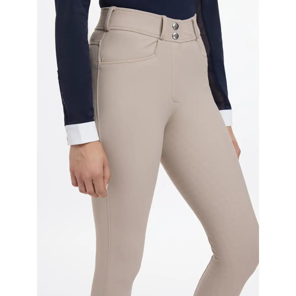 Beige high waisted lemieux isabelle seat breeches almond with buttoned belt and tailored fit for riding comfort
