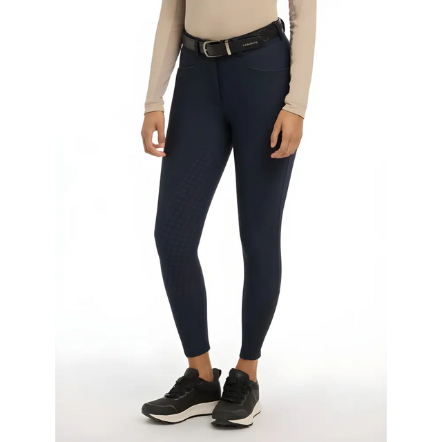 Navy seat breeches styled with a beige top and black sneakers from Lemieux Isabelle