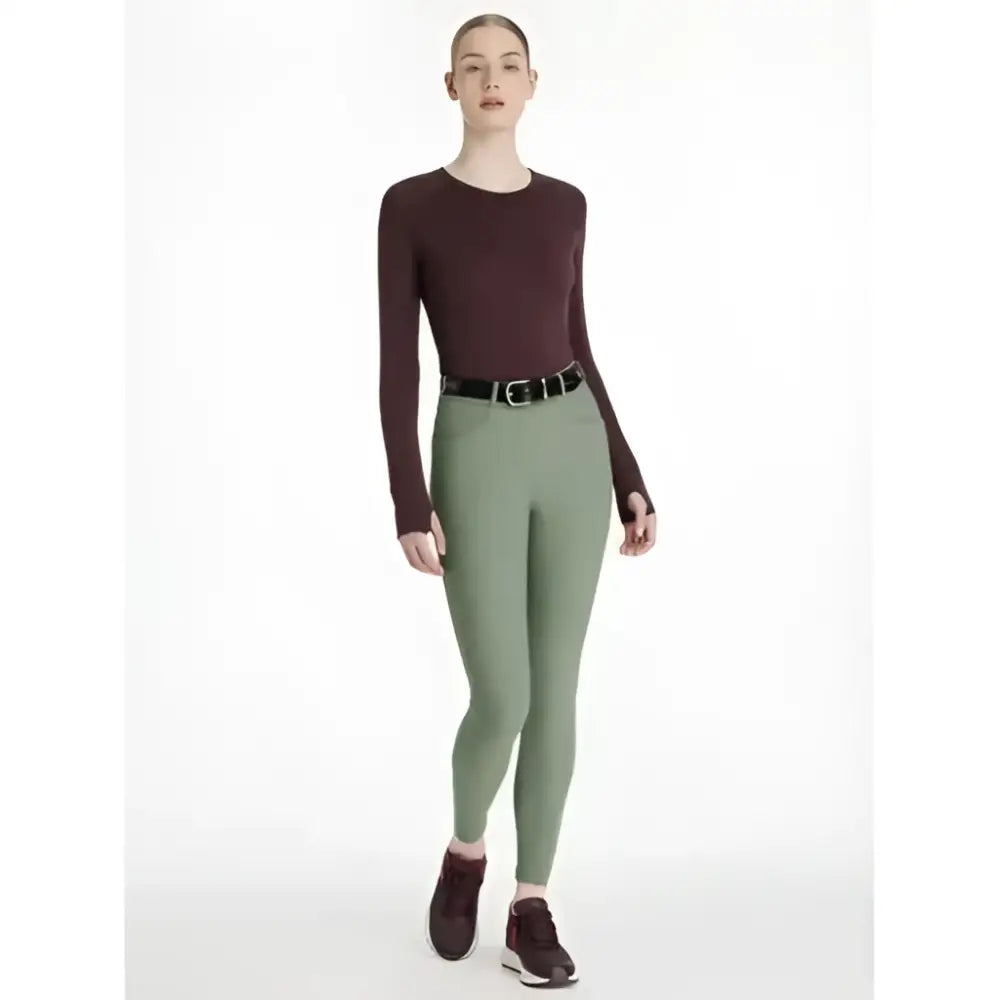 Maroon long-sleeved top with round neckline and fitted silhouette paired with lemieux isabelle seat breeches rosemary