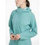 A sleek teal lemieux isla short waterproof jacket lagoon with high collar and subtle hood details perfect for wet weather