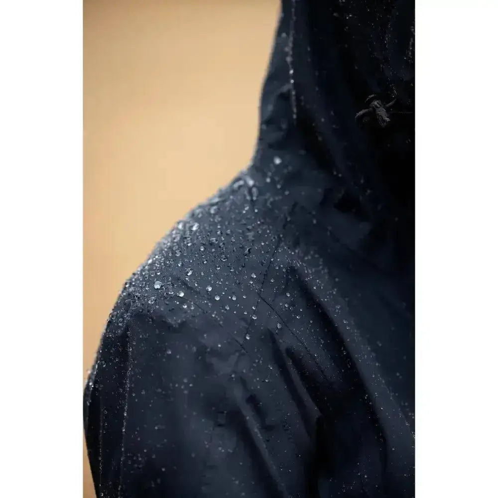 Lemieux isla short waterproof jacket navy with black waterproof material and water droplets beading on its surface