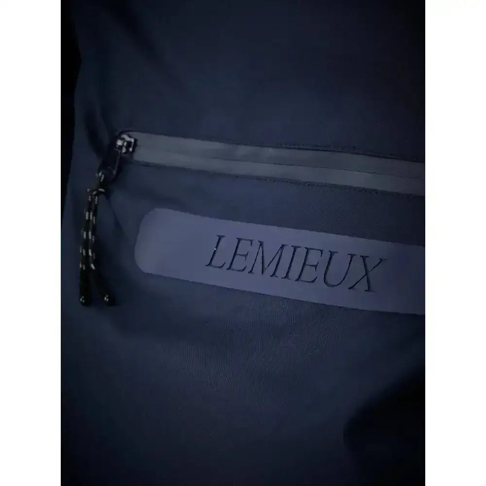 Navy lemieux isla short waterproof jacket shown with a dark blue fabric pouch with a silver zipper and white lemieux label