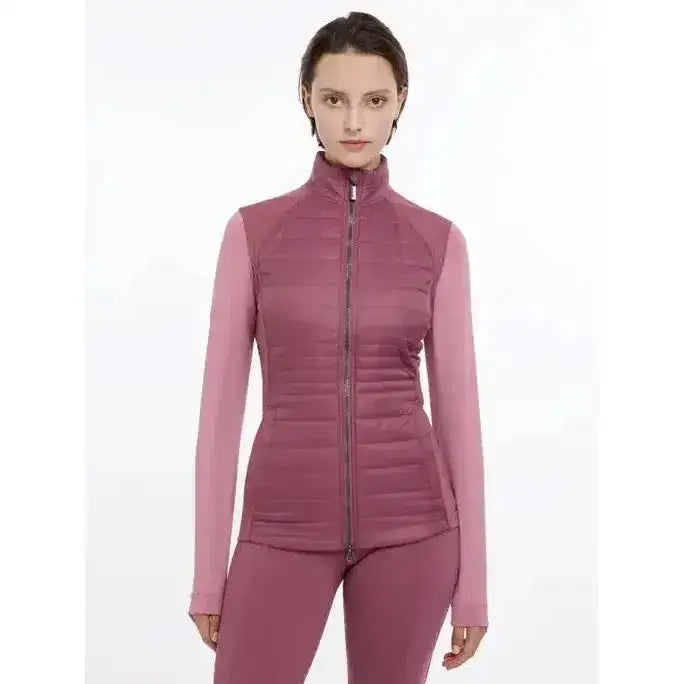 A mauve quilted zip-up lemieux juliette gilet rosewood with long sleeves and high collar paired with matching leggings