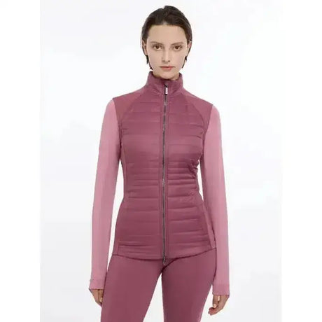 A mauve quilted zip-up lemieux juliette gilet rosewood with long sleeves and high collar paired with matching leggings