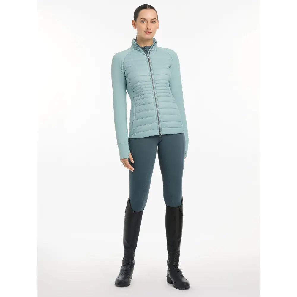 Light blue Lemieux Juliette Jacket Glacier paired with dark pants and tall boots