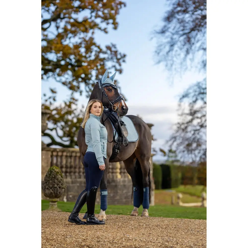 Horse with rider and companion showcasing the Lemieux Juliette Jacket Glacier