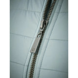 Metal zipper detail on light-colored quilted Lemieux Juliette Jacket Glacier fabric