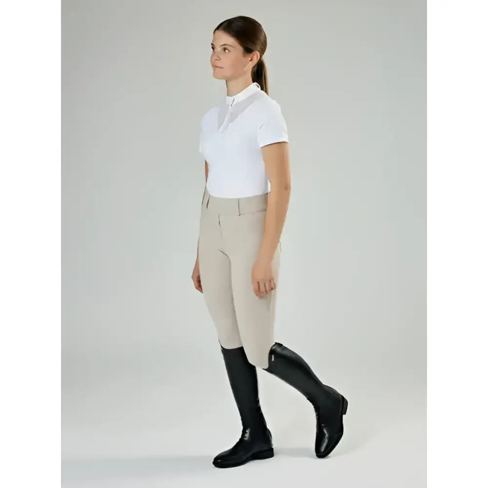 Beige equestrian riding pants with fitted waistband and side seam detail paired with lemieux junior field riding boot black