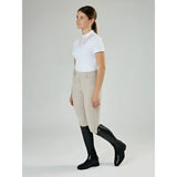 Beige equestrian riding pants with fitted waistband and side seam detail paired with lemieux junior field riding boot black