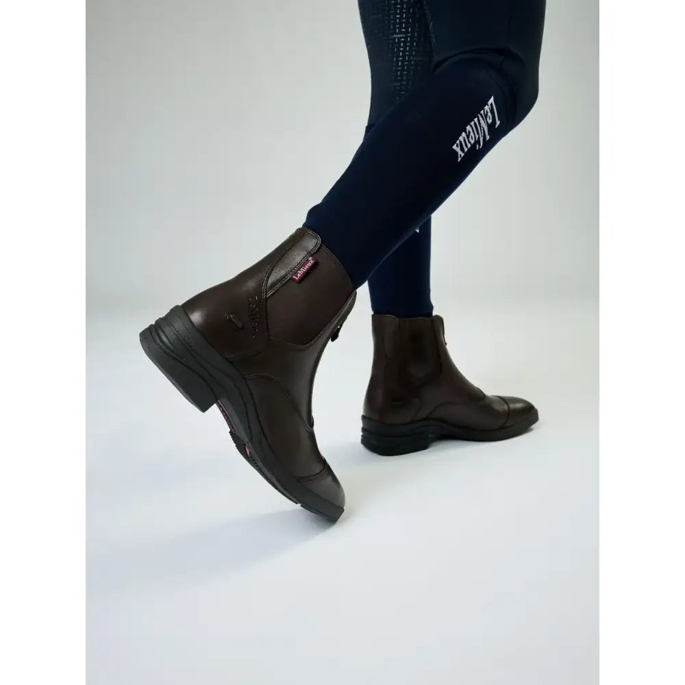Dark brown leather lemieux junior zip paddock boot with side zipper and black rubber soles for riding use