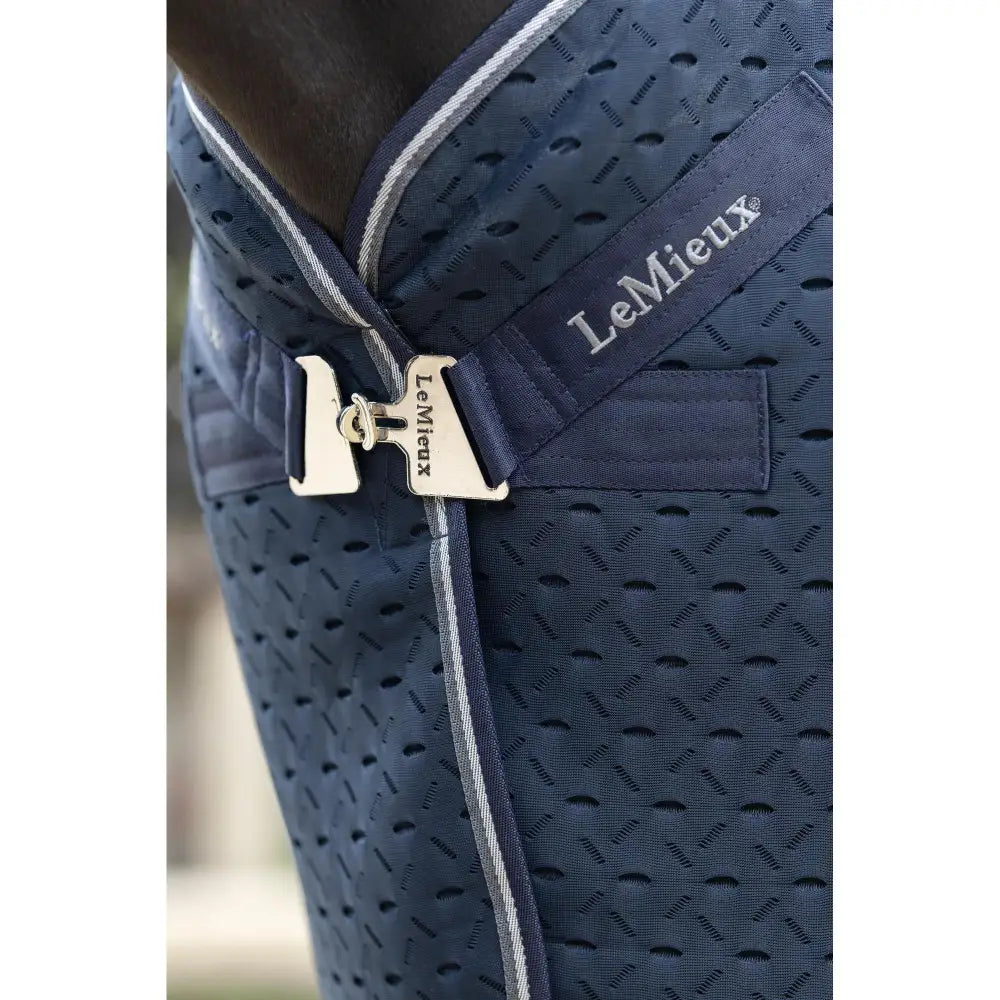 Navy blue lemieux kudos mesh travel rug with silver buckle and removable protective tail for horses