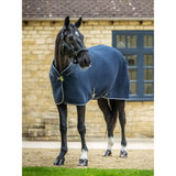Navy blue lemieux kudos mesh travel rug with perforated design white trim silver buckles and removable protective tail