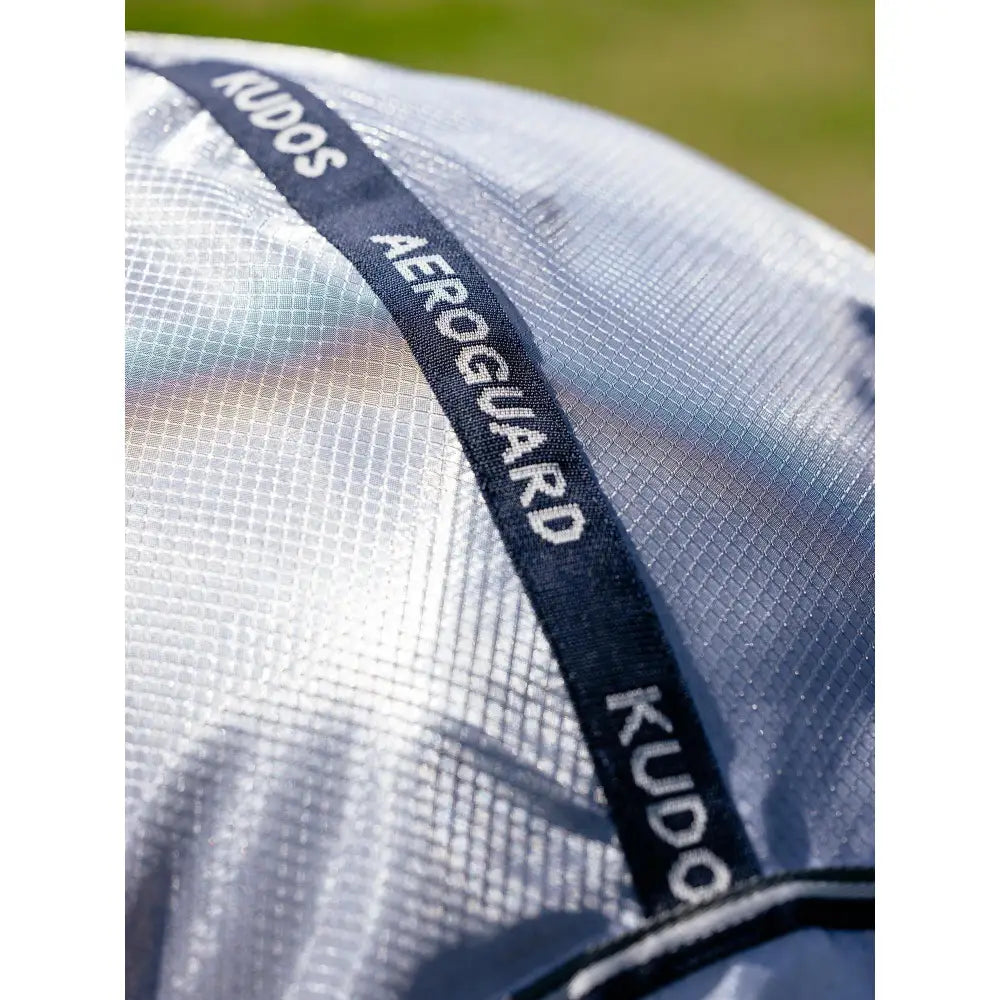 Silver mesh lemieux kudos aeroguard horse fly mask with black branded strap featuring white kudos text