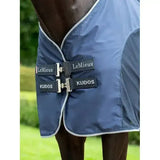 Navy blue lemieux kudos hybrid horse blanket with white trim and silver buckles designed as kudos hybrid cooler navy