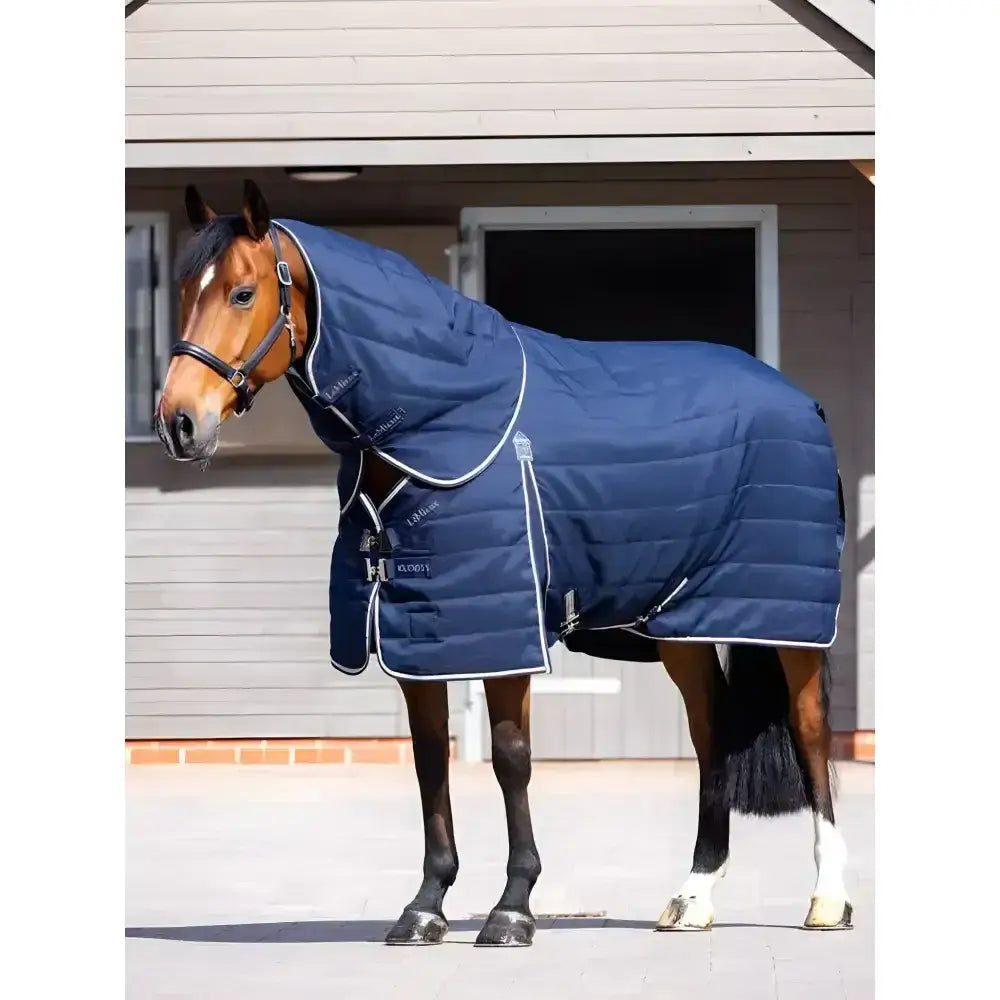 Navy blue quilted lemieux kudos stable neck cover with white trim and silver hardware for horse warmth