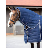Navy blue quilted lemieux kudos stable neck cover with white trim and black leather straps for horses
