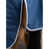 Horse in a blue Lemieux Kudos Stable Rug 100g Navy with white trim