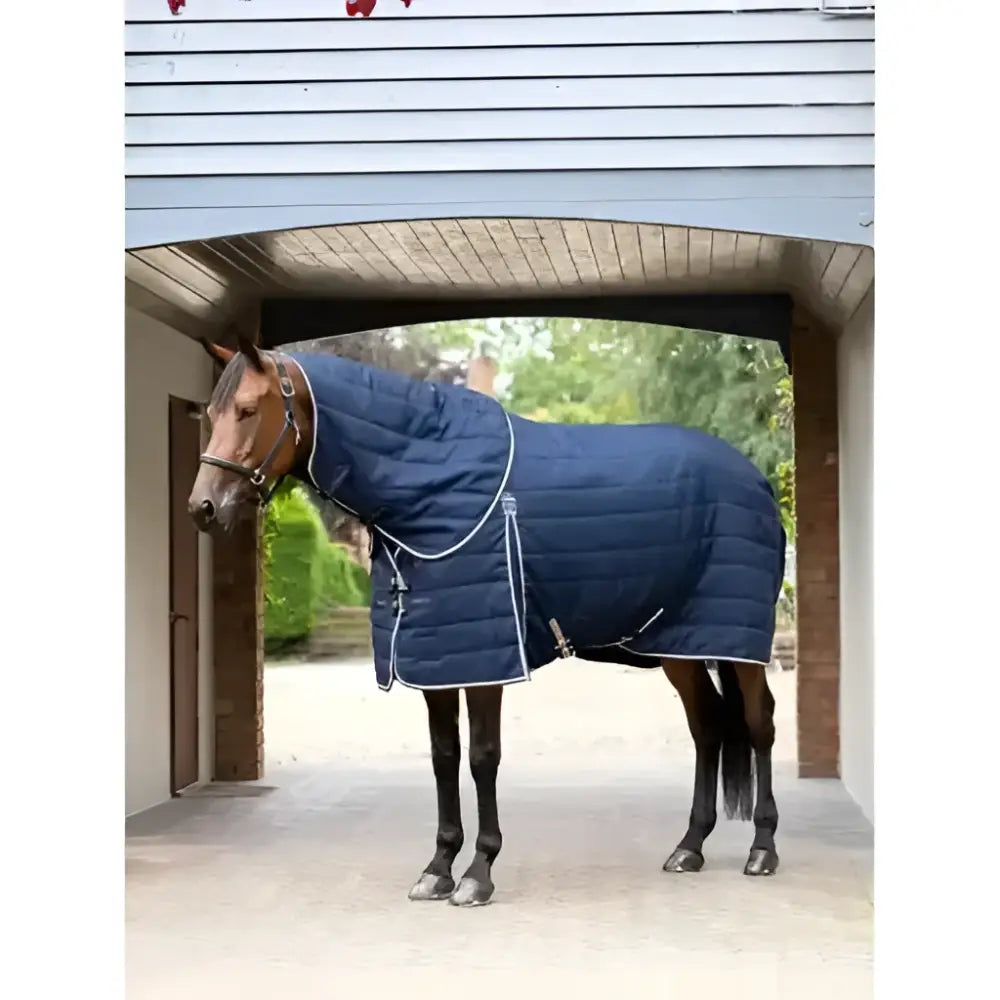 Navy blue quilted lemieux kudos stable rug with white stitching and silver hardware perfect for horses