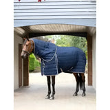 Navy blue quilted lemieux kudos stable rug with white stitching and silver hardware perfect for horses