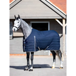 Gray horse wearing a navy blue Lemieux Kudos Stable Rug 50g for optimal warmth