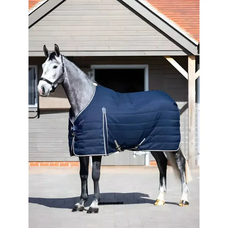 Navy blue quilted lemieux kudos stable rug 50g with white trim and silver buckles perfect for stable use