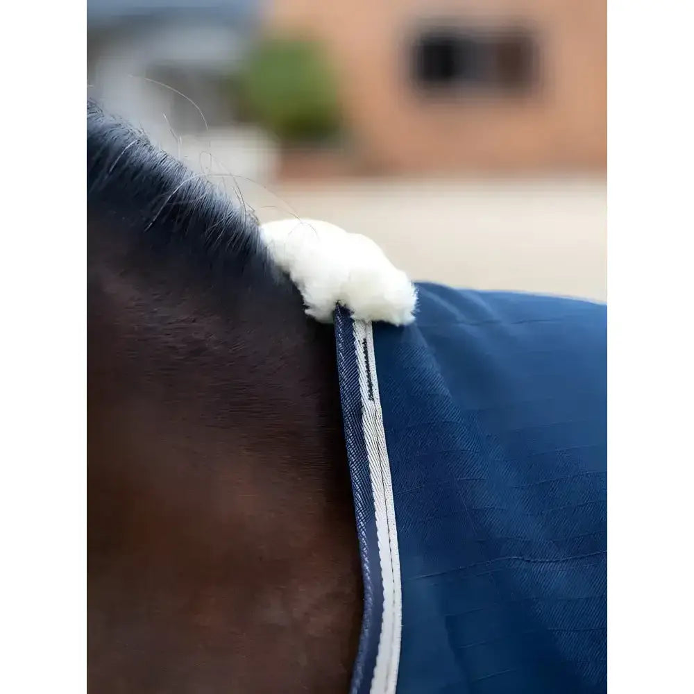 Blue denim lemieux kudos stable rug 50g with white fleece trim and fluffy white end for cozy stable use