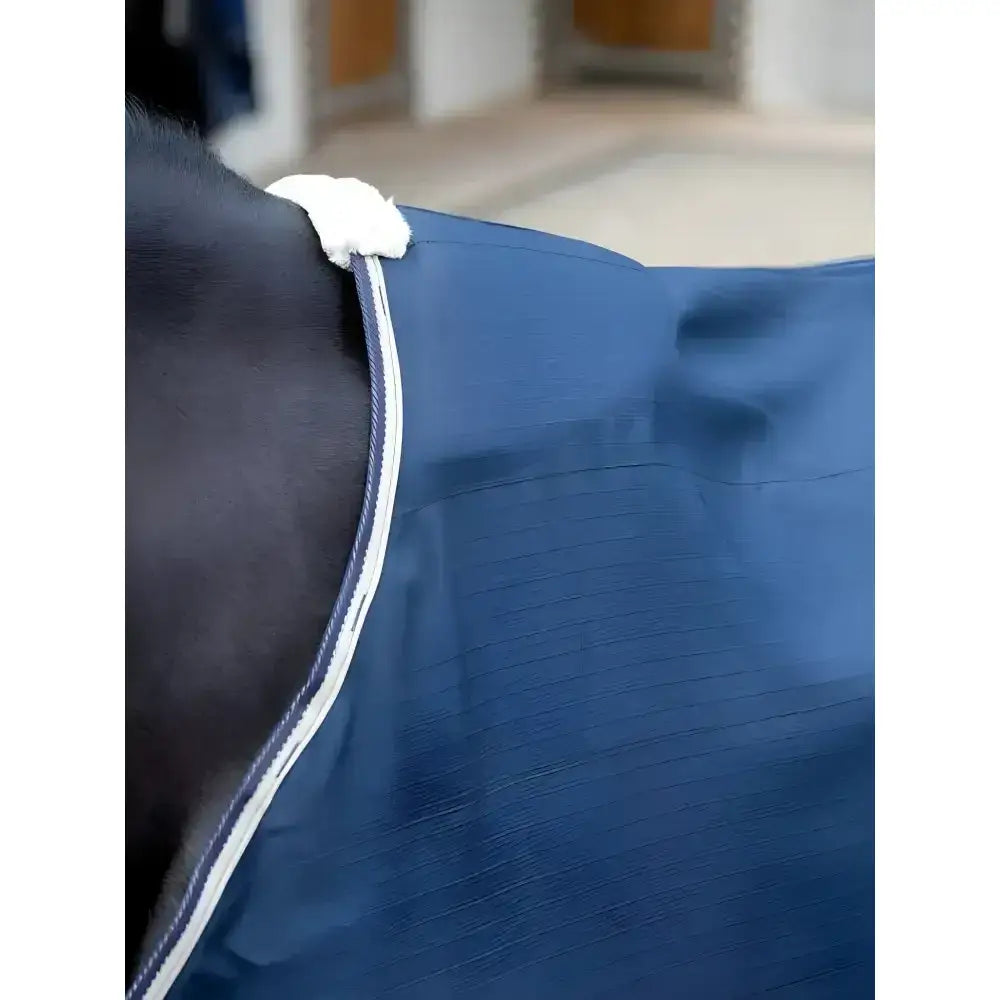 Blue lemieux kudos stable sheet navy with white trim and fluffy white strap for horse comfort and protection