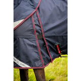 Navy blue lemieux kudos thermo layer turnout rug with red trim reflective white stripe and brand logo on side