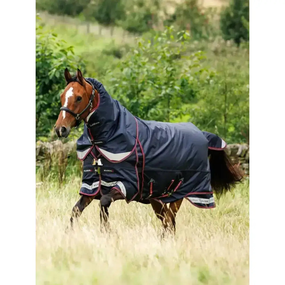 Navy blue lemieux kudos thermo layer turnout rug 300g with red and white trim and branded chest logo