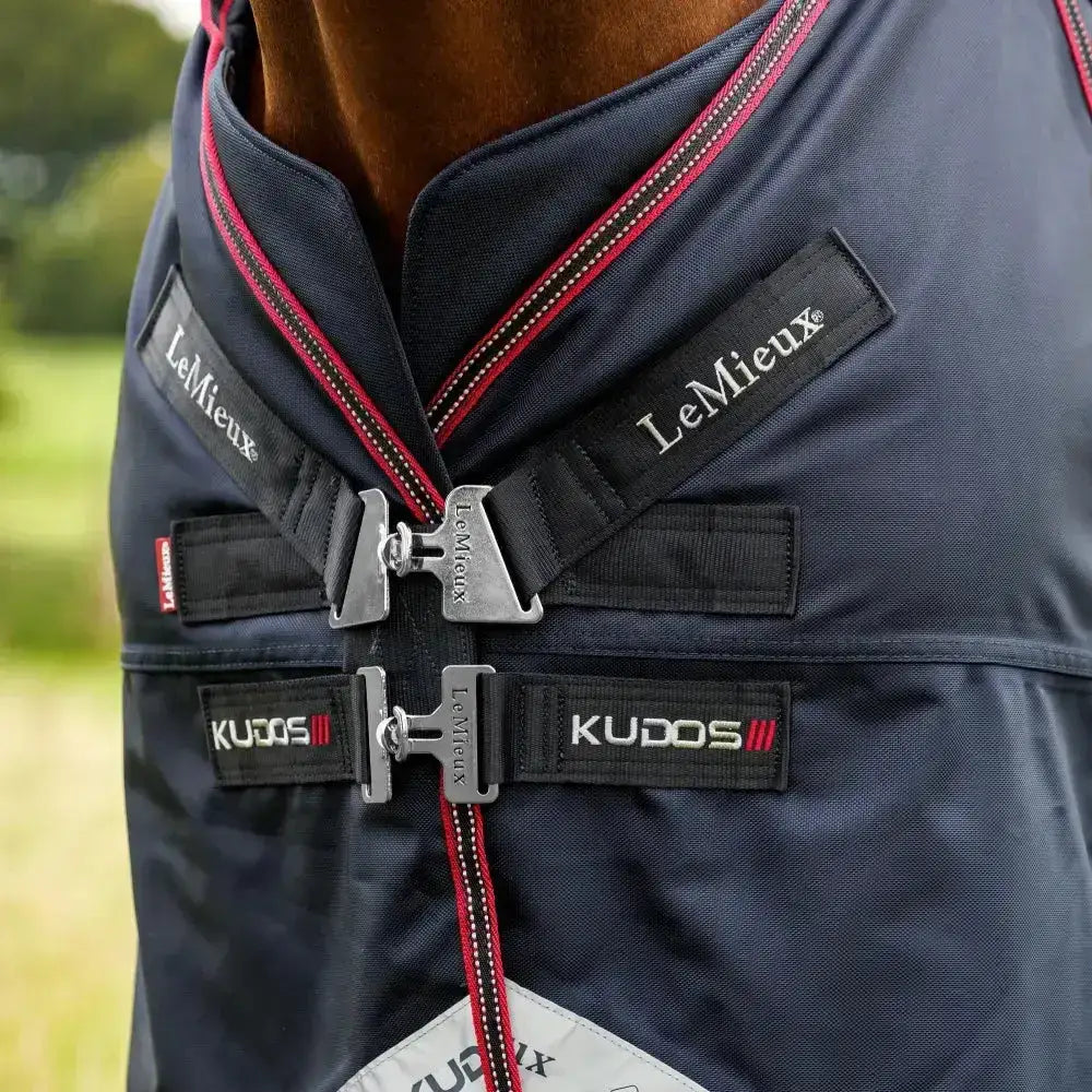 Navy blue lemieux kudos thermo layer turnout rug 300g with red trim silver buckles and branded black straps