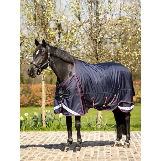 Navy blue lemieux kudos turnout rug 100g with maroon and white trim, adjustable straps, and reflective strips for visibility