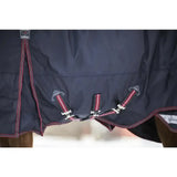 Dark navy lemieux kudos turnout rug 100g with red and white striped straps and silver buckles for horses